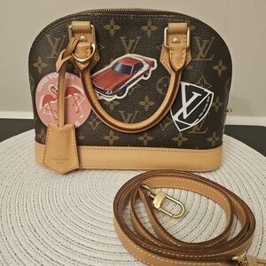 Louis Vuitton Alma BB World Tour Monogram Crossbody Bag